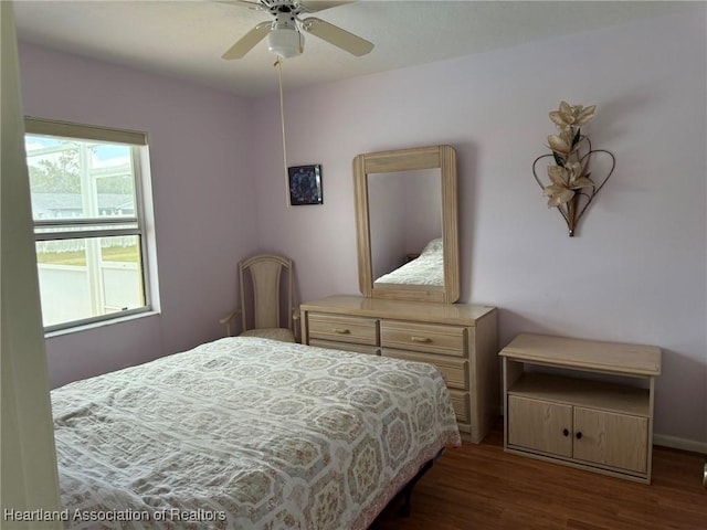 bedroom featuring dark hardwood / wood-style floors and ceiling fan