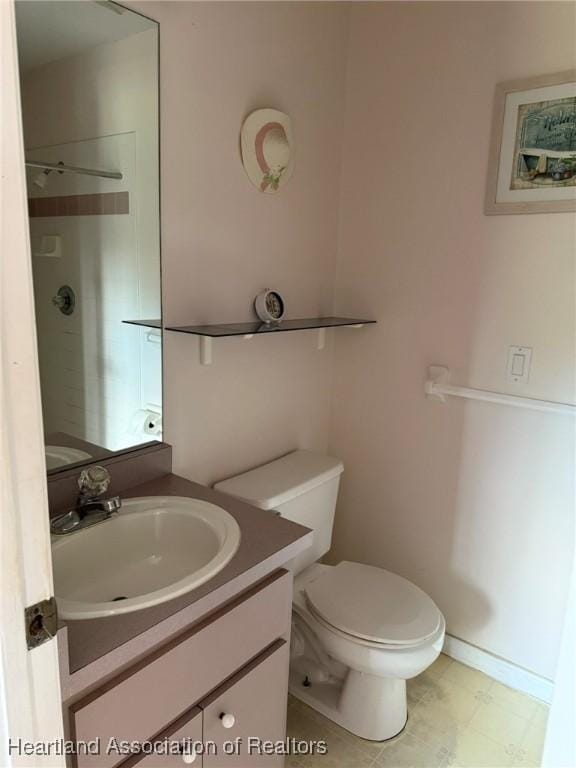 bathroom with walk in shower, vanity, and toilet