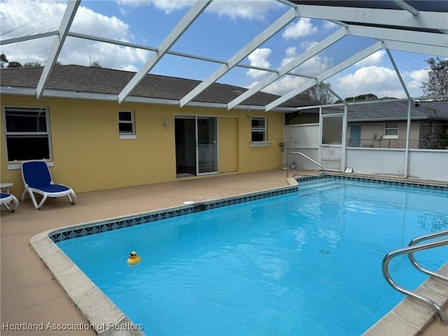 view of pool featuring a patio area and glass enclosure