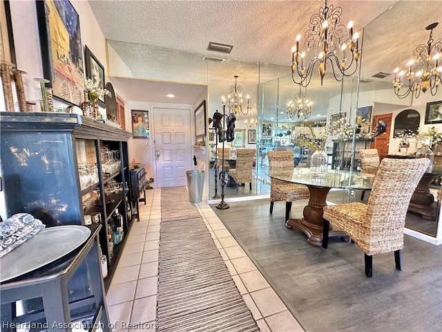 tiled dining area with a textured ceiling