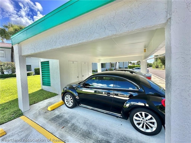 view of parking with a yard and a carport