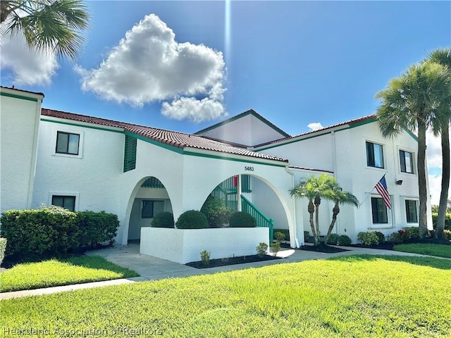 mediterranean / spanish-style house featuring a front lawn