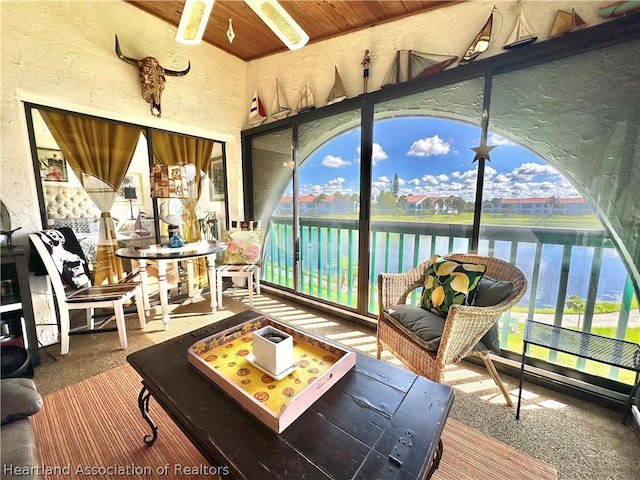 sunroom featuring a water view and plenty of natural light