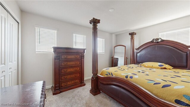 1076 Sugarwood St, Davenport, FL 33837 - carpeted bedroom with a closet and baseboards