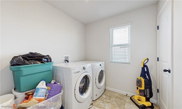 1076 Sugarwood St, Davenport, FL 33837 - washroom with washer and clothes dryer and baseboards