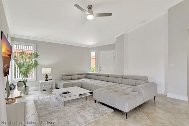 living room with ceiling fan, ornamental molding, and light tile patterned flooring