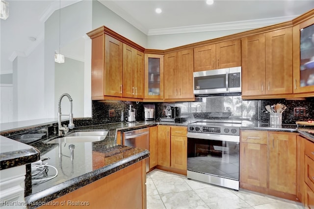 kitchen with appliances with stainless steel finishes, dark stone counters, sink, pendant lighting, and lofted ceiling