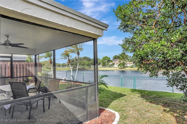 exterior space with a water view, plenty of natural light, and ceiling fan