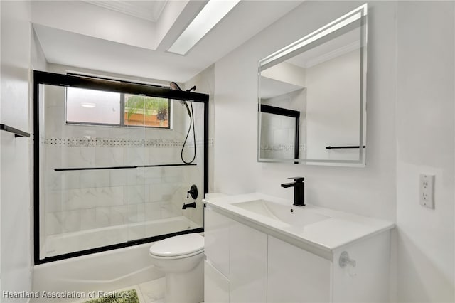 full bathroom featuring toilet, vanity, and combined bath / shower with glass door