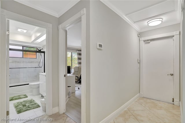 corridor with light tile patterned floors and ornamental molding