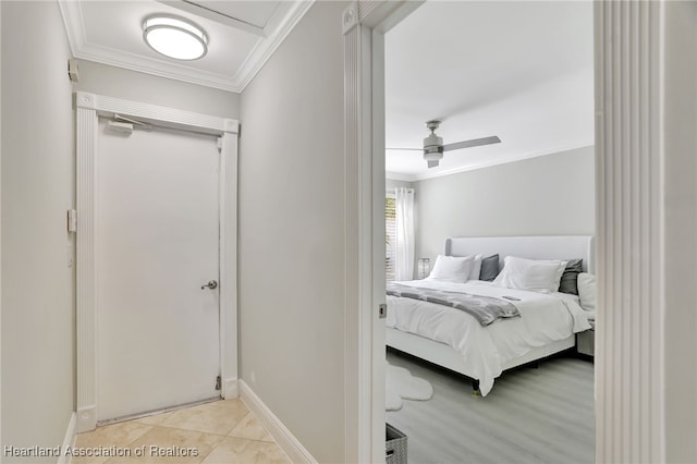 tiled bedroom featuring ceiling fan and crown molding