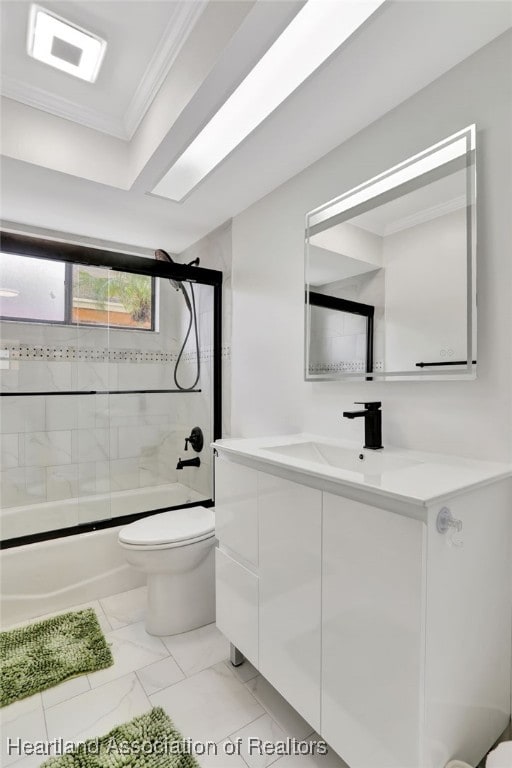 full bathroom with crown molding, vanity, bath / shower combo with glass door, and toilet