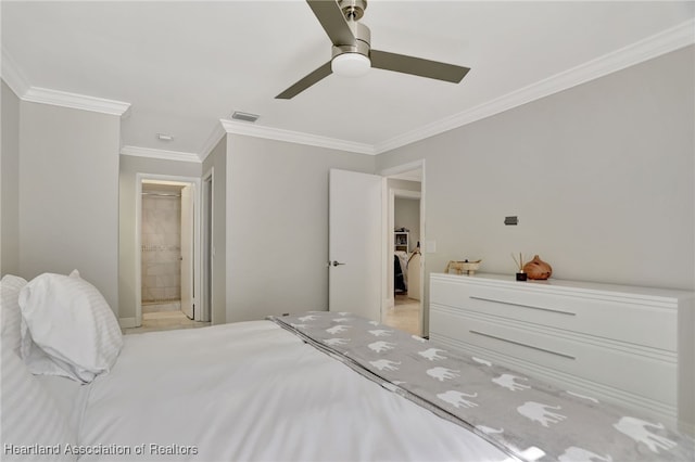 bedroom with ceiling fan, crown molding, and ensuite bath