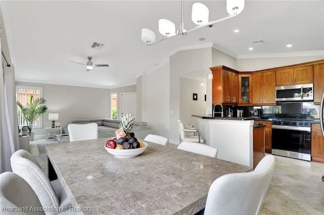 dining space featuring ceiling fan with notable chandelier, lofted ceiling, and crown molding