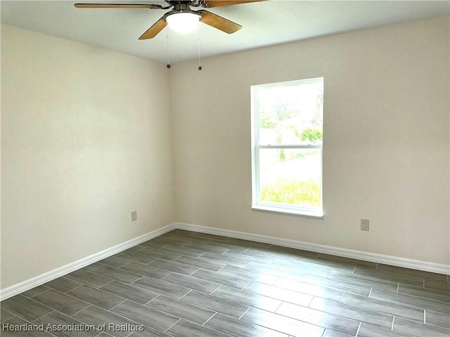 spare room featuring ceiling fan and a healthy amount of sunlight