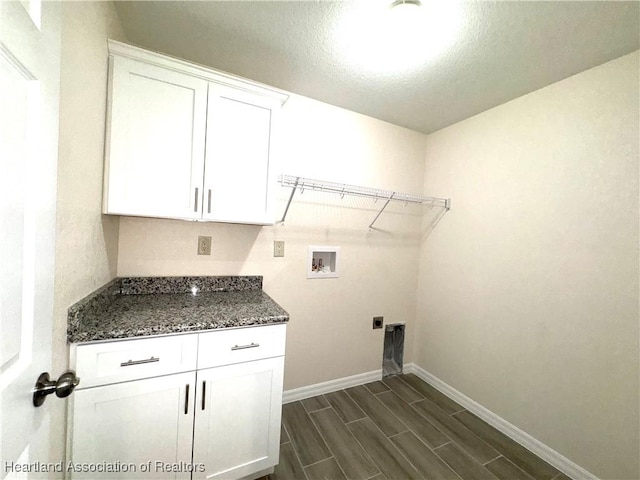 laundry room with cabinets, washer hookup, a textured ceiling, and hookup for an electric dryer