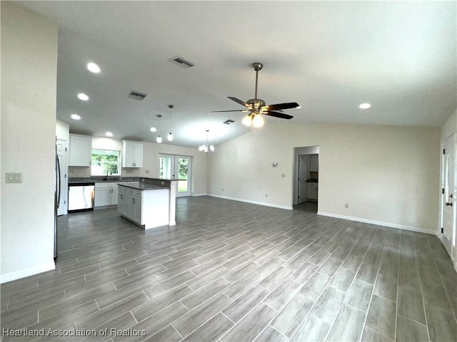 kitchen featuring white cabinetry, dishwasher, a center island, lofted ceiling, and ceiling fan with notable chandelier