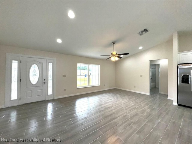 entrance foyer with ceiling fan and vaulted ceiling