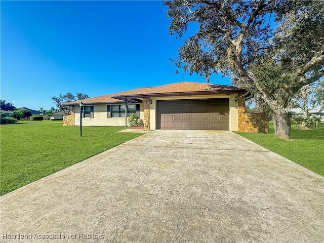 ranch-style home featuring a garage and a front lawn