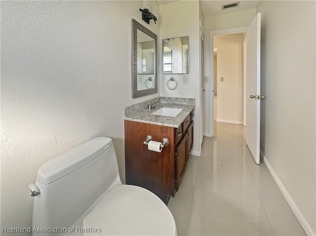 bathroom with tile patterned floors, vanity, and toilet