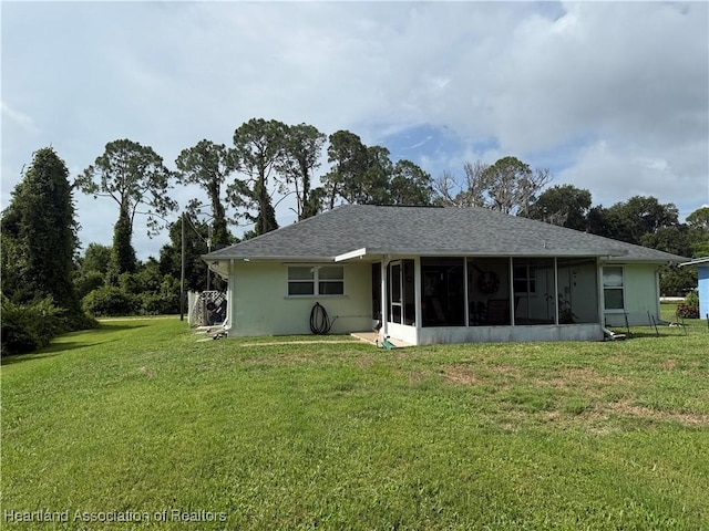 1502 Paper Birch St, Lake Placid, FL 33852 - back of property featuring a sunroom, a yard, and roof with shingles