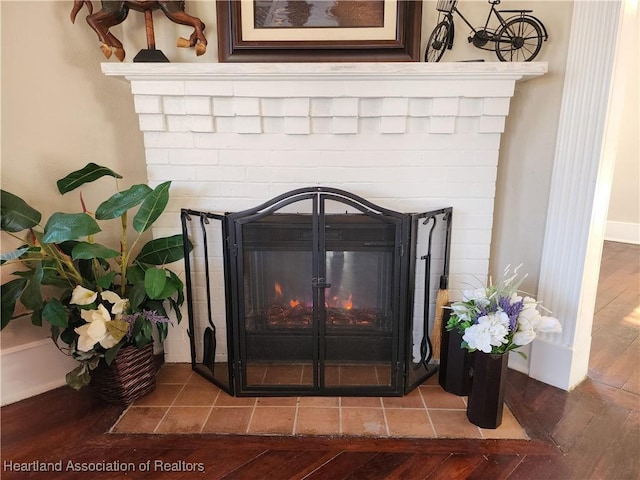 room details featuring wood finished floors and a fireplace