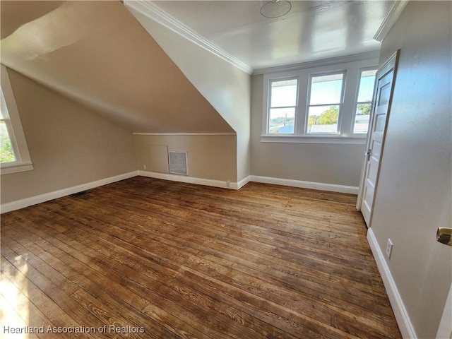 additional living space with visible vents, baseboards, lofted ceiling, and dark wood finished floors