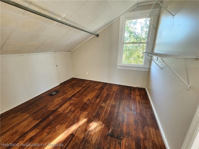 bonus room featuring dark wood-style floors, visible vents, and lofted ceiling