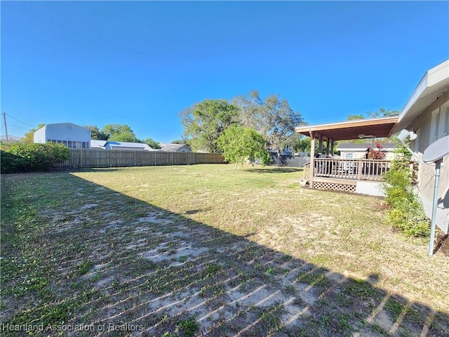 view of yard featuring a wooden deck and a fenced backyard