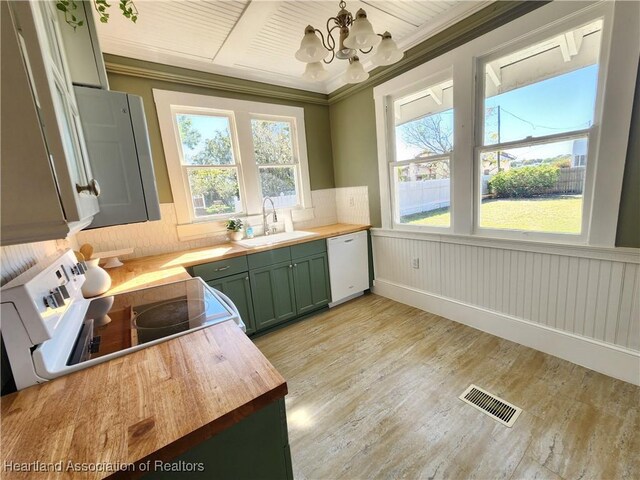 kitchen featuring visible vents, a sink, wood counters, white appliances, and green cabinetry