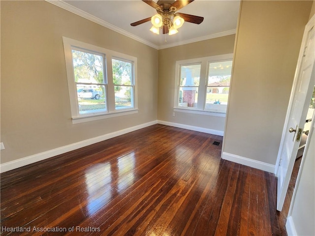 spare room featuring baseboards, plenty of natural light, and ornamental molding