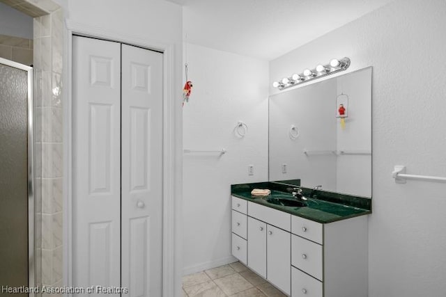 bathroom featuring a stall shower, a closet, and vanity