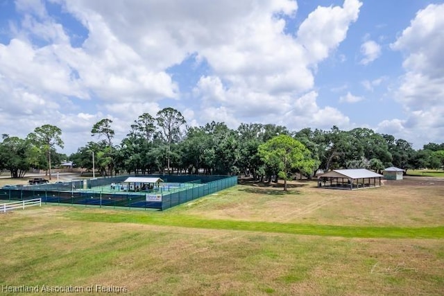 view of property's community with fence and a yard