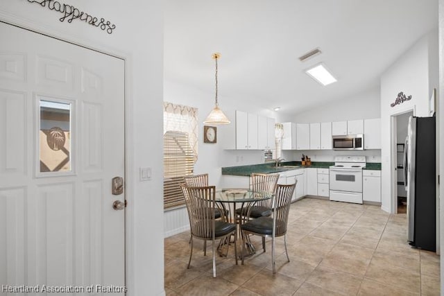 dining space with lofted ceiling, light tile patterned flooring, and visible vents