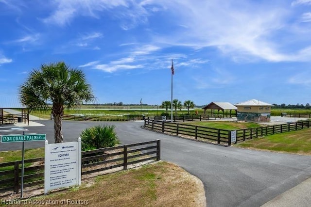 surrounding community featuring a rural view, a gazebo, and fence