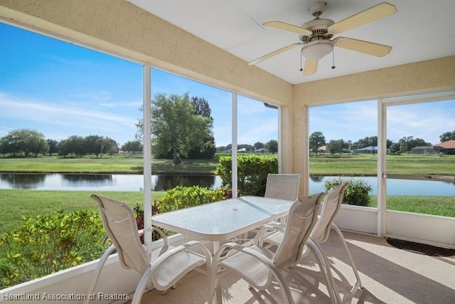 sunroom / solarium featuring outdoor dining area, a water view, and ceiling fan