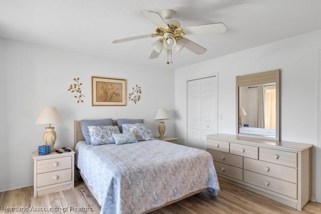 bedroom with a ceiling fan, a closet, and light wood finished floors