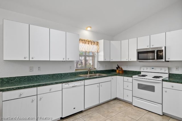 kitchen featuring white cabinetry, white appliances, lofted ceiling, and a sink