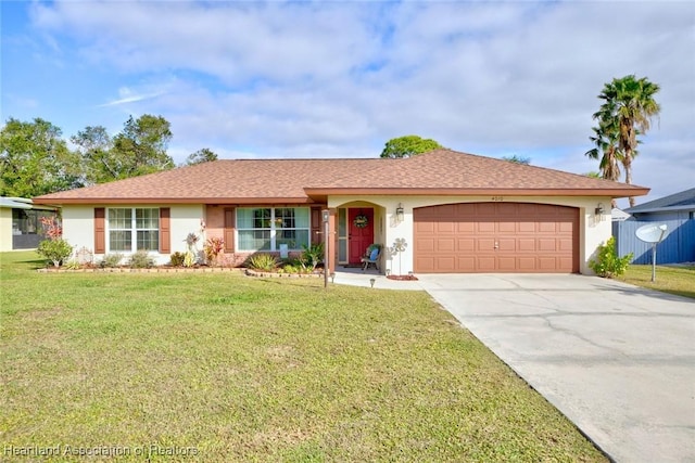 ranch-style house featuring a garage and a front lawn