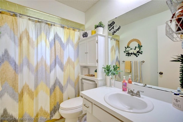 bathroom featuring vanity, a textured ceiling, toilet, and a shower with shower curtain