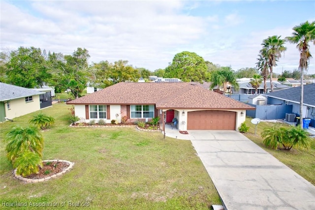 ranch-style house featuring cooling unit, a garage, and a front lawn