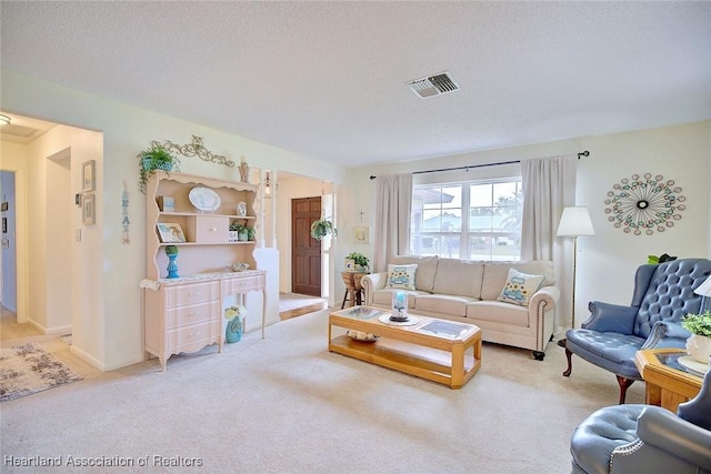 carpeted living room featuring a textured ceiling