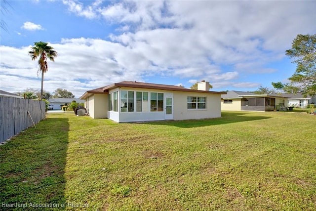 rear view of house with a lawn