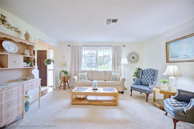 living room with light carpet and a textured ceiling