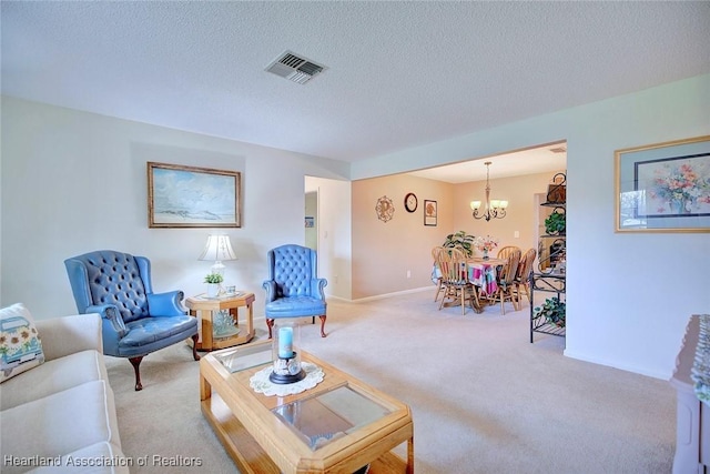 living room featuring carpet flooring, a textured ceiling, and a notable chandelier