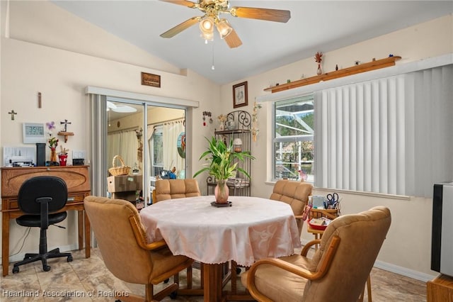 dining area featuring lofted ceiling, a ceiling fan, and baseboards