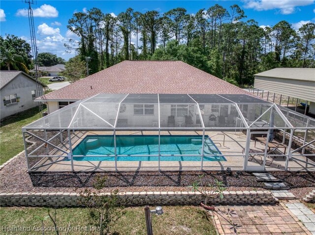 pool with a lanai and a patio