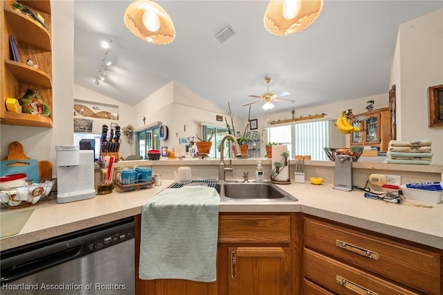 kitchen with lofted ceiling, light countertops, stainless steel dishwasher, and visible vents