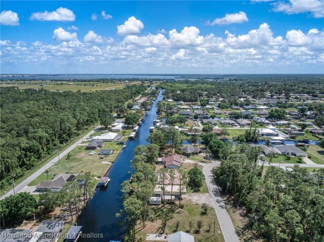 birds eye view of property featuring a water view and a residential view