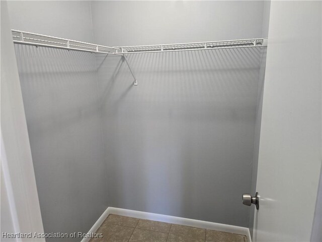 spacious closet featuring tile patterned floors